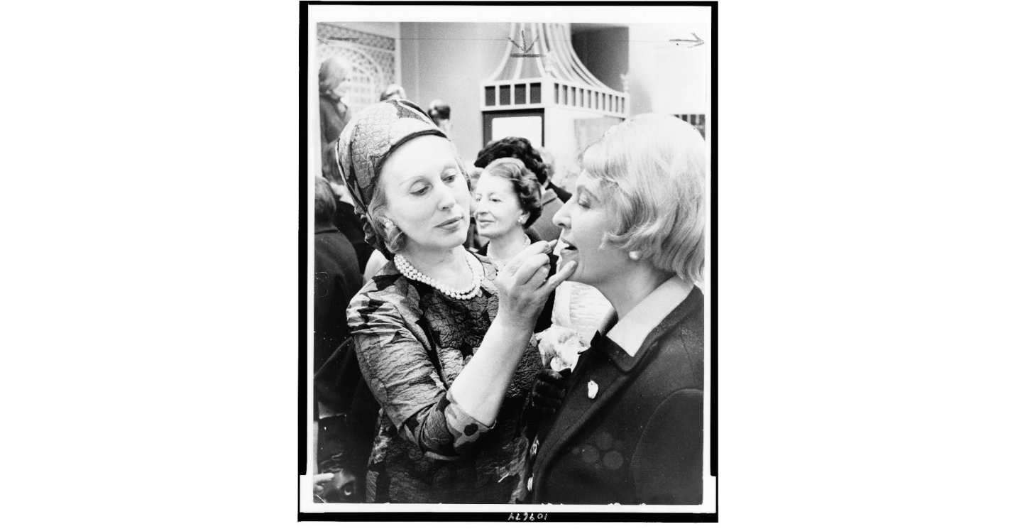 Estée Lauder applying lipstick to a customer, 1966–67